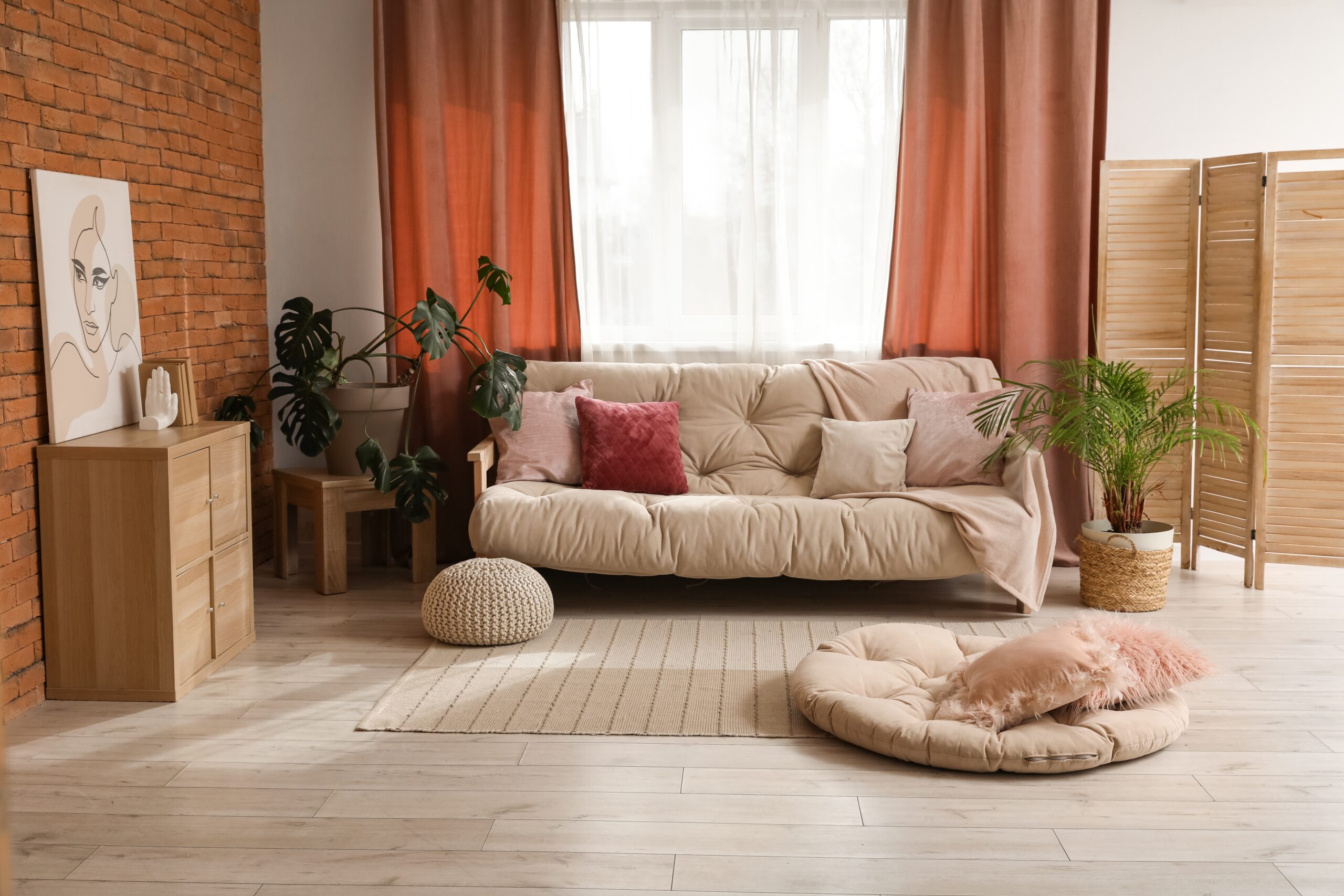 Comfortable,Sofa,Near,Window,With,Red,Curtains,In,Living,Room